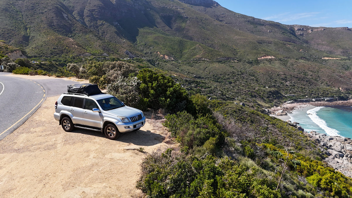 SUV with King Neptune Rooftop Storage Bag with scenic view of the ocean